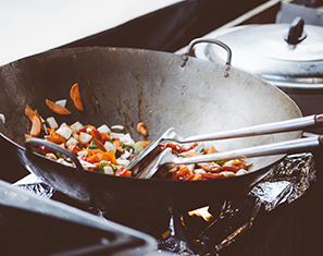 Frying vegetables in a wok